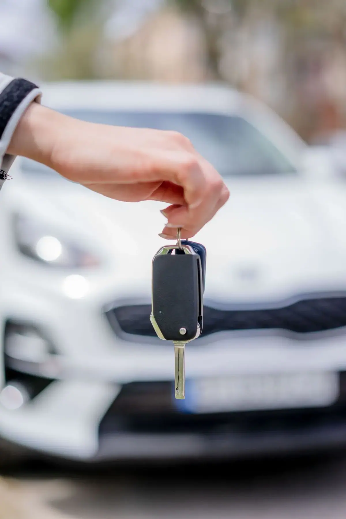 Hand holding a new replacement car key fob in Costa Mesa CA