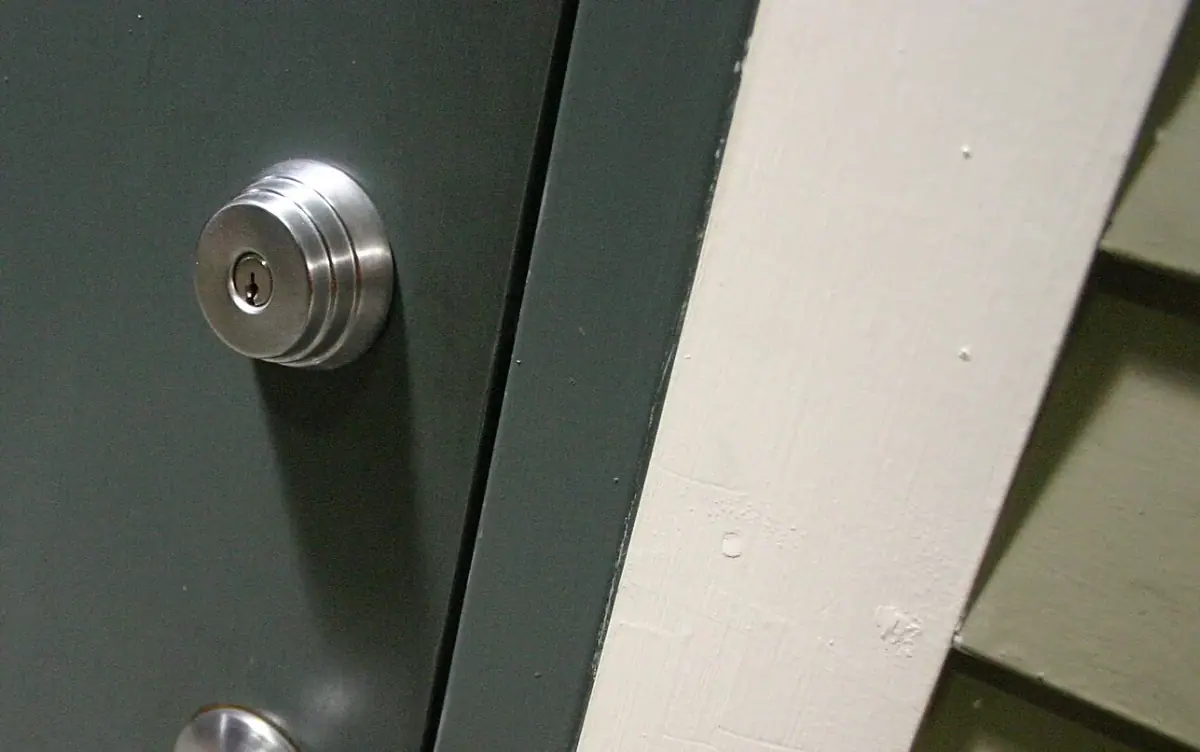 New brass deadbolt installed on a wooden door in Costa Mesa CA