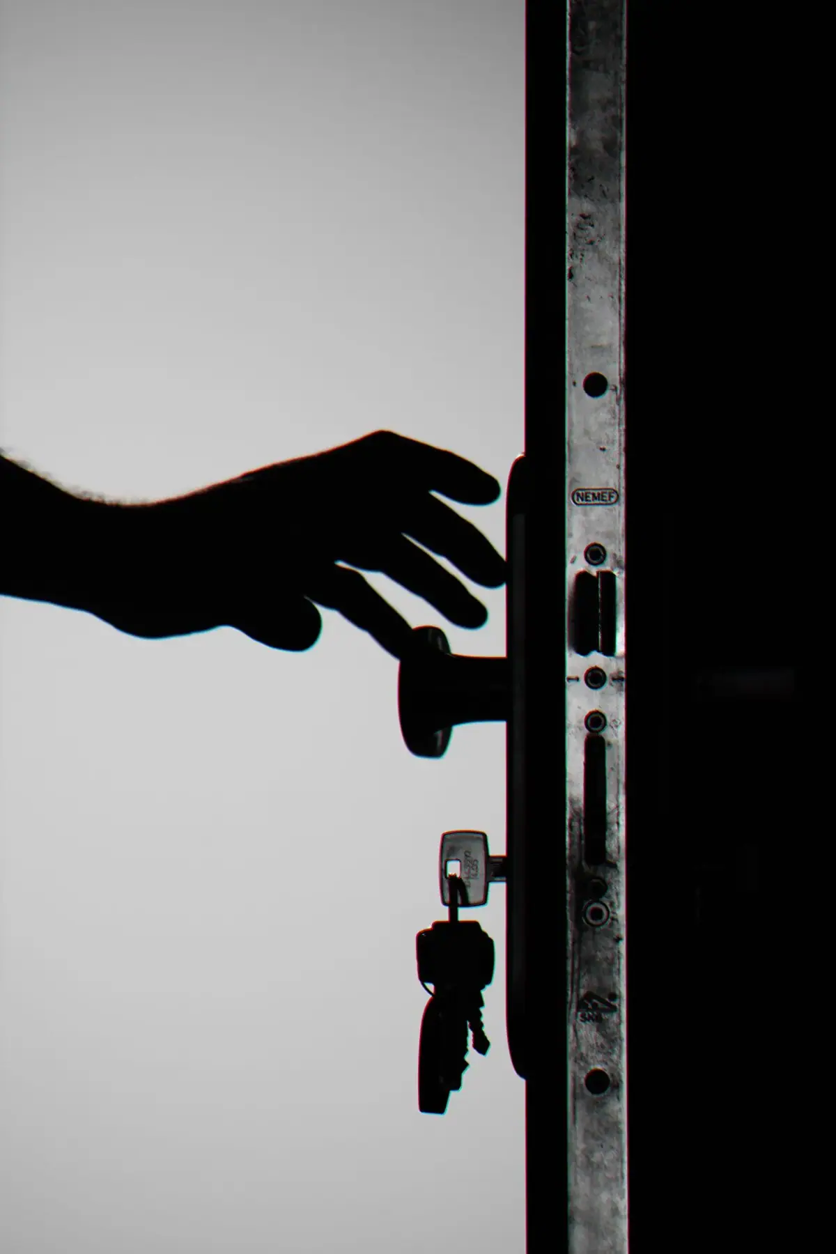 Hand reaching for a door handle with keys, emergency locksmith Costa Mesa