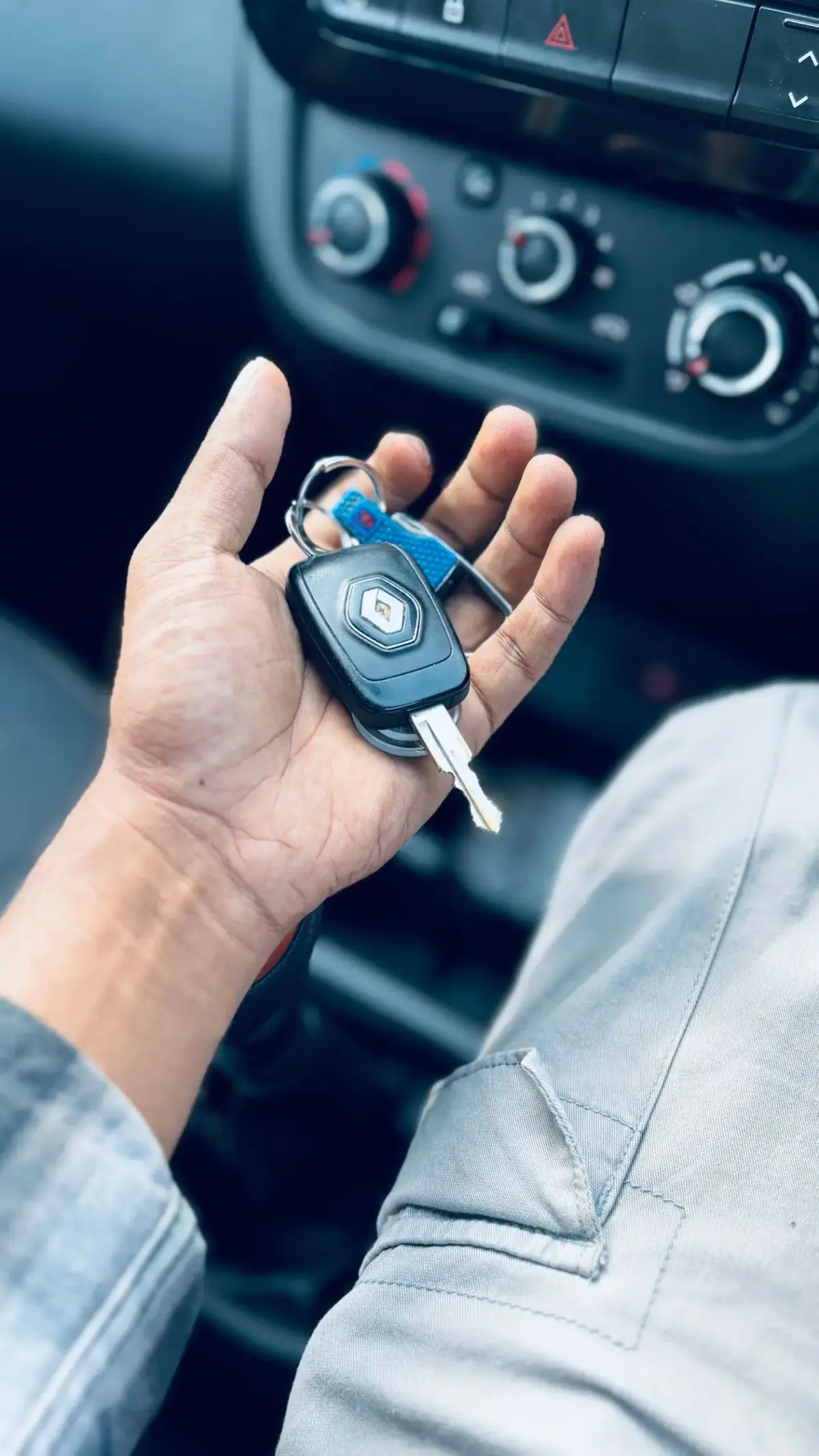 Hand holding a car key fob, key fob programming in Costa Mesa CA