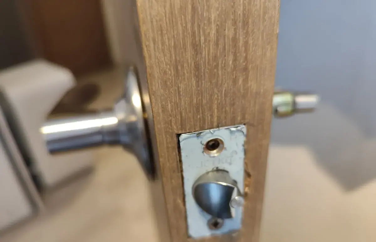 Locksmith installing a new deadbolt lock during a lock change in Costa Mesa