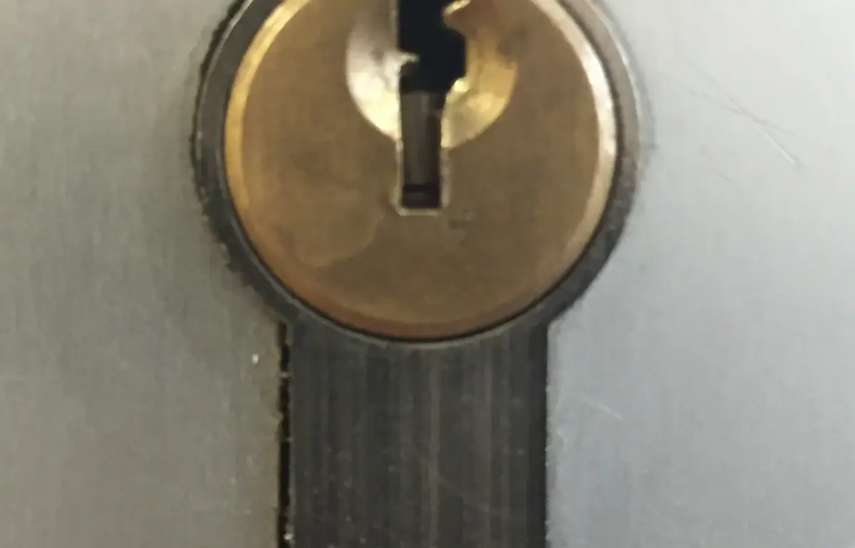 Locksmith repairing a lock cylinder with professional tools in Costa Mesa