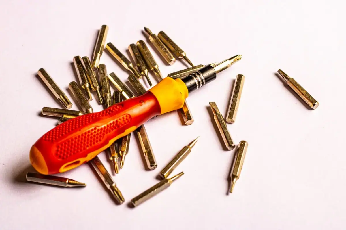 Screwdriver and screws ready for a lock change in Costa Mesa