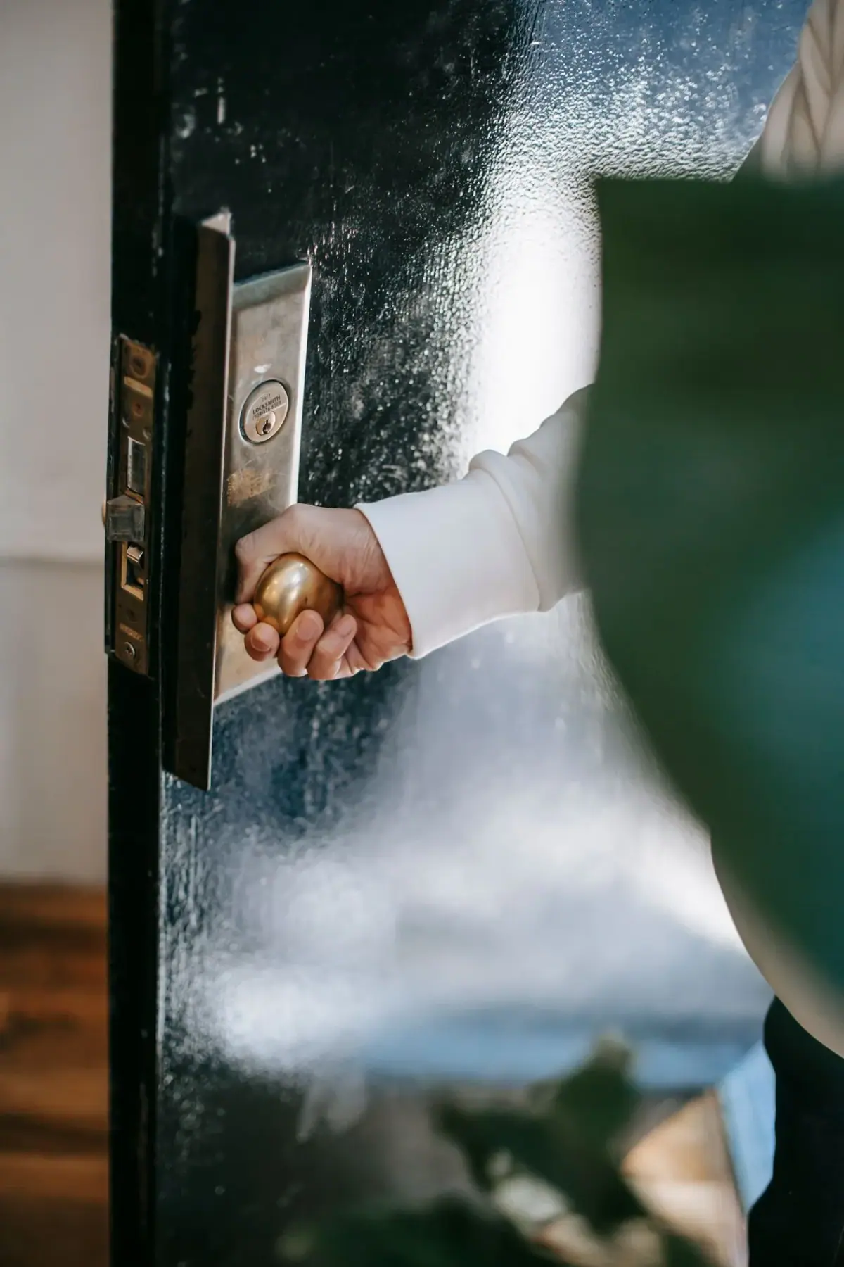Hand opening a home door handle, residential locksmith in Costa Mesa